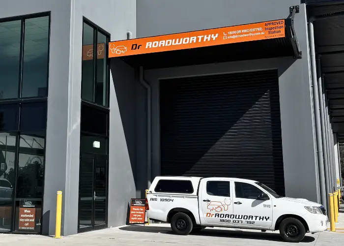 Mechanic performing a mobile roadworthy inspection on a car in Brisbane